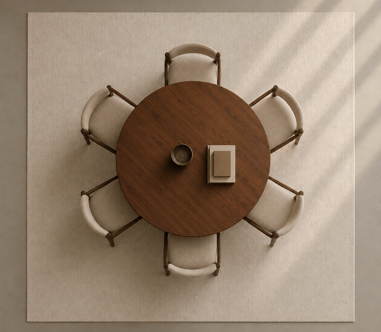 Overhead view of a round dark wood dining table surrounded by six matching chairs with cream upholstered seats, placed on a large beige rug against a light wall with soft diagonal shadows.