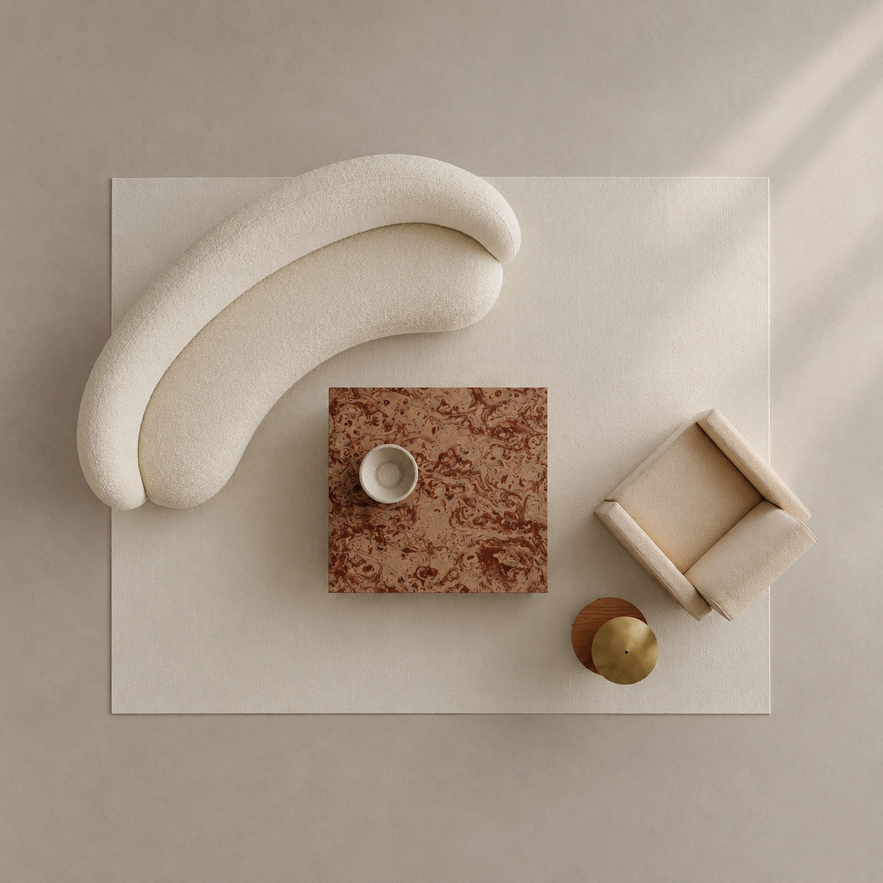 A top-down styled interior scene showing a cream curved accent chair, a small beige armchair, a rectangular terracotta side table with a white cup, and a round gold object arranged on a large cream rug against a warm beige wall.